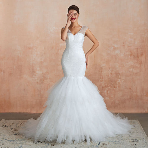 White V-neck fishtail wedding dress with beaded bodice and layered tulle skirt.