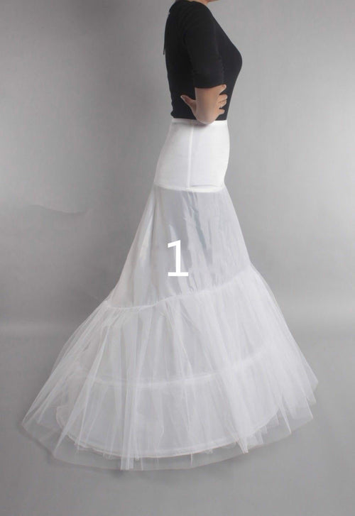 White bridal petticoat with layered tulle and structured hoops, worn with a black top.