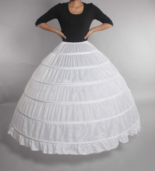 White crinoline petticoat with six hoops, flared shape, worn under black top.