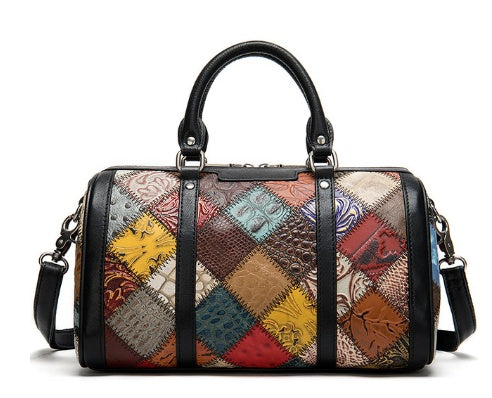 Multi-colored leather patchwork handbag with black handles and shoulder strap.