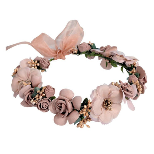 Pink silk flower crown with roses, small gold berries, and a sheer pink bow.
