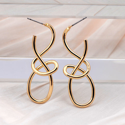 Pair of gold-plated metal earrings featuring an abstract knotted and looped drop design.
