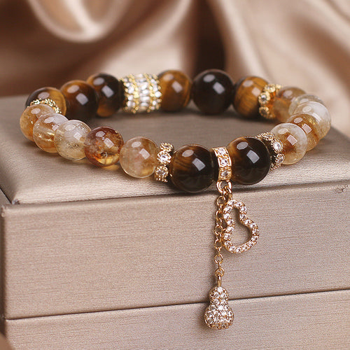 Beaded bracelet with golden citrine and dark tiger eye beads, featuring a rhinestone-paved gourd charm.
