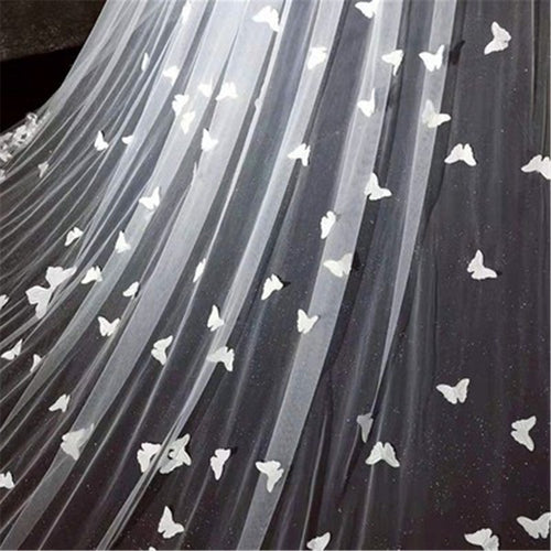White tulle veil with scattered white butterfly appliques and subtle glitter.