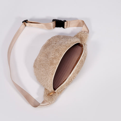 Fluffy beige sherpa fanny pack with open zippered pocket revealing brown and white striped lining.