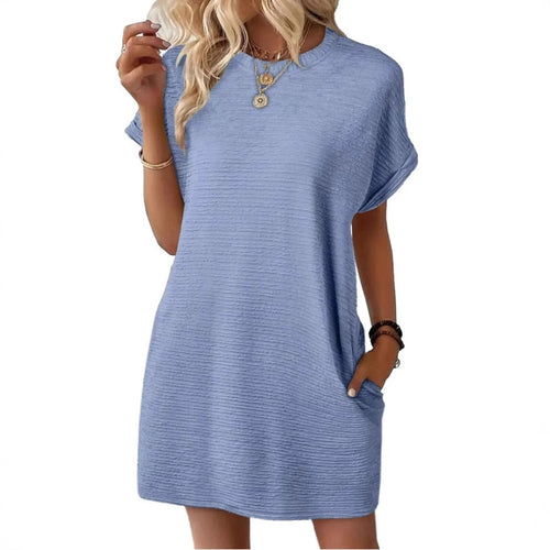 A model wearing a blue short-sleeve textured shift dress with side pockets.