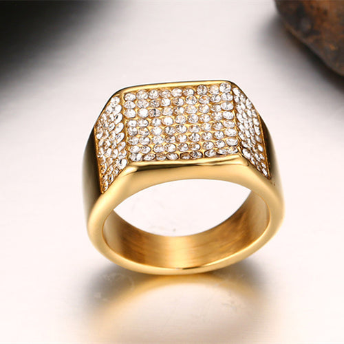 Wide gold titanium ring with a square, crystal-paved top face.