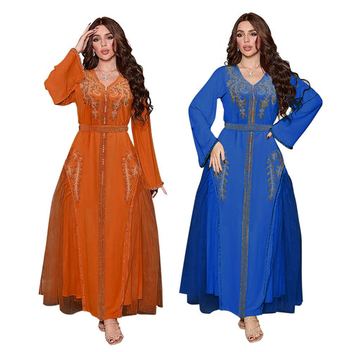 Two models wearing long-sleeved, floor-length dresses in orange and blue, adorned with intricate gold embroidery.