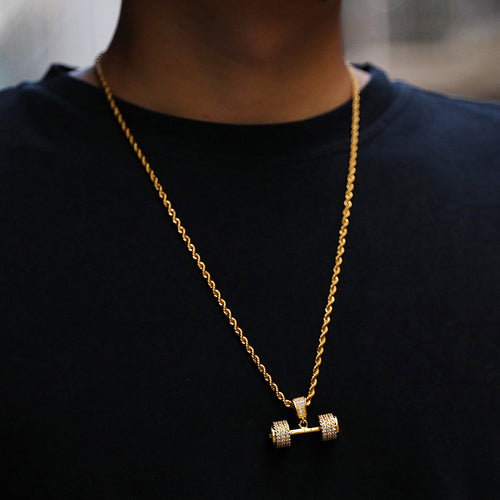 Gold rope chain necklace with a dumbbell-shaped diamond pendant worn against a black shirt.