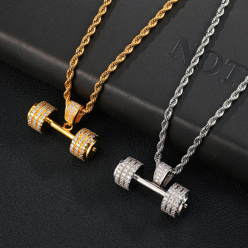 Two dumbbell pendant necklaces with rope chains, one gold and one silver, paved with sparkling cubic zirconia.
